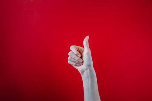 Big Thumbs Up On Red Background Photo