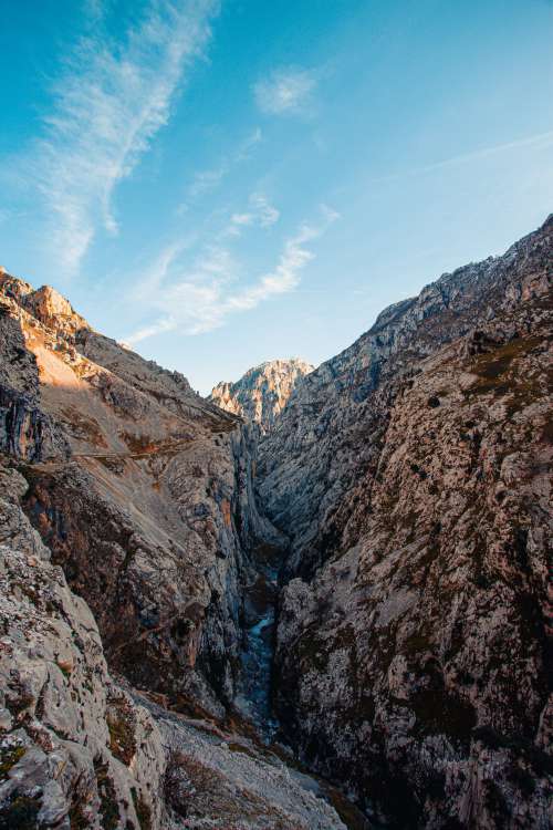Water Flows Through A Narrow Valley In Mountains Photo