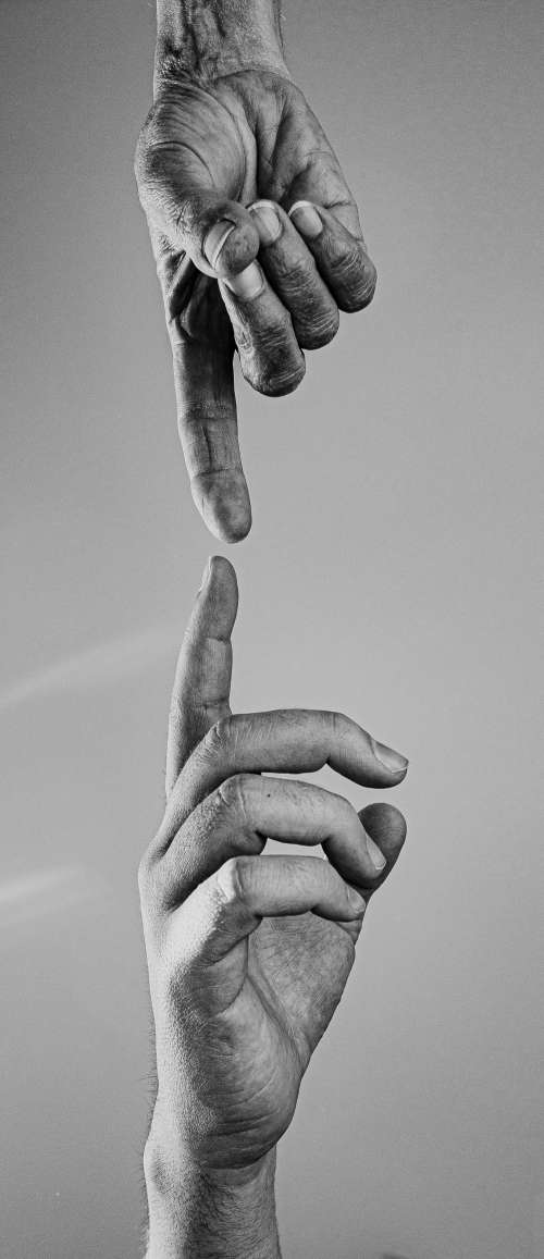 Two Reaching Hands In Black And White Photo