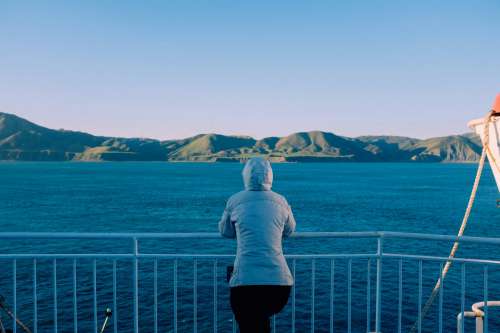 Woman Takes In The Mountain View From Ferry Photo