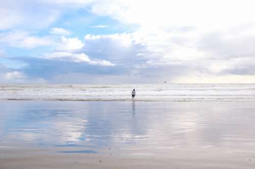 Woman Wades Through Water At Beach Photo