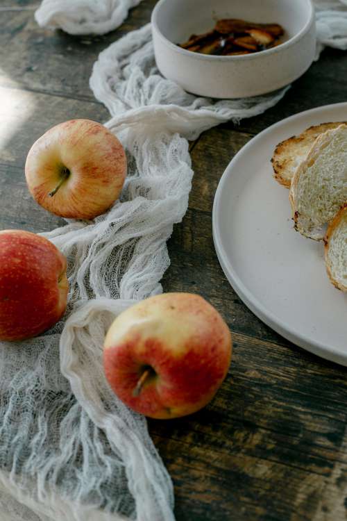 Fresh Bread And Apples On Rustic Table Photo