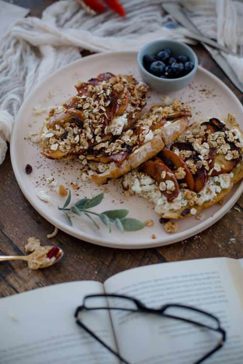 Fresh Bread Covered In Fruit With A Book Photo
