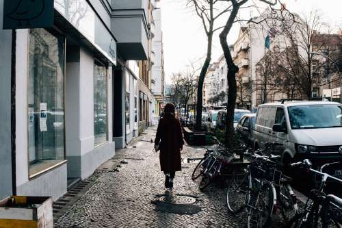 Woman Walks Along The Cobbled Streets Photo