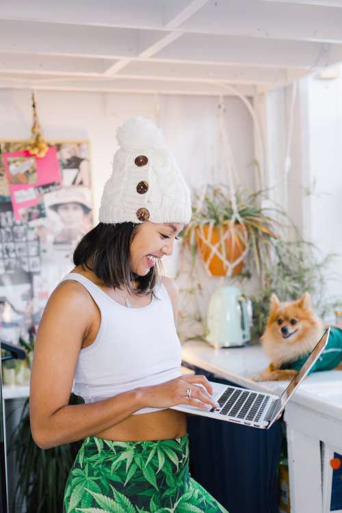 A Woman Smiles At Her Laptop Photo