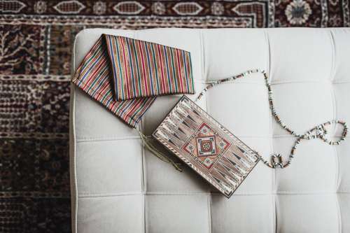 A Wooden Bag With A Beaded Handle Photo