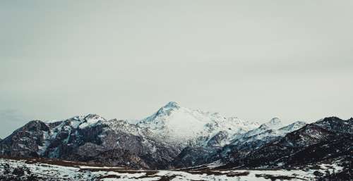 Vast Snowcapped Mountain Under Grey Sky Photo