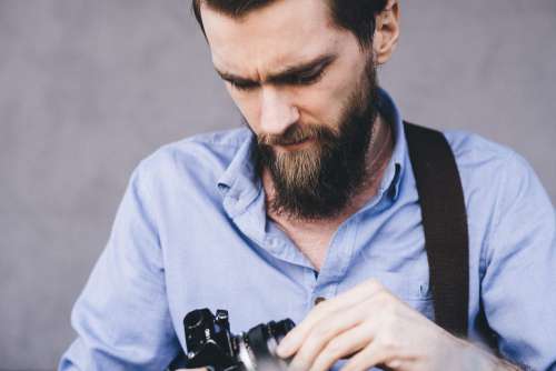 A man holding an analog camera