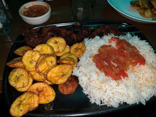 rice, tomato juice, fried banana, plantain, barbecue, meat, restaurant, fast food, snack, food, delicious, aloko, taste, flavor, nutrition, diet