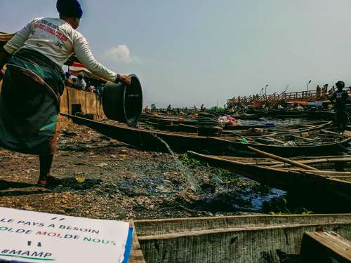 people, travel, water, watercraft, landscape, calamity, junk, dirty riverbank, fishermen, boats, canoes, gestural, woman