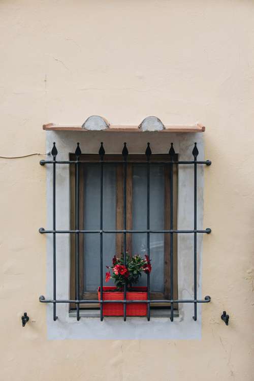 Window With Iron Guards On Yellow Building Photo