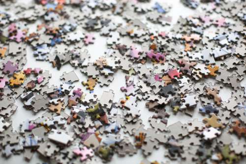Puzzle Pieces Scattered Across A Surface Photo