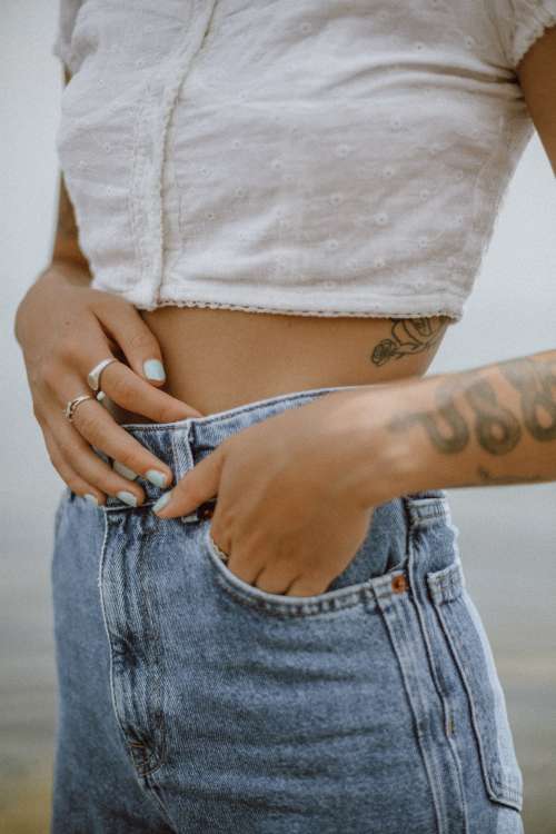 A Fashionable Person With Tattoos Poses Photo