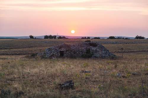 Sunset Over Small Pile Of Rubble Photo