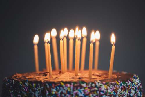 Close Up Of Candles Lit On Chocolate Cake Photo