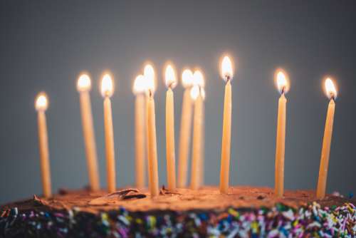Candles On An Illuminated Chocolate Cake Photo