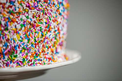 Sprinkles On A Chocolate Cake With Plate Photo
