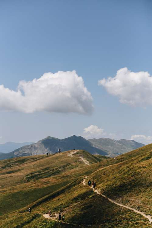 Mountains And Hikers On A Pathway Photo
