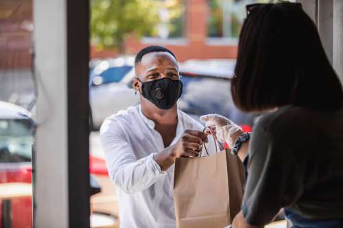 Man Picks Up His Order From A Local Shop Photo