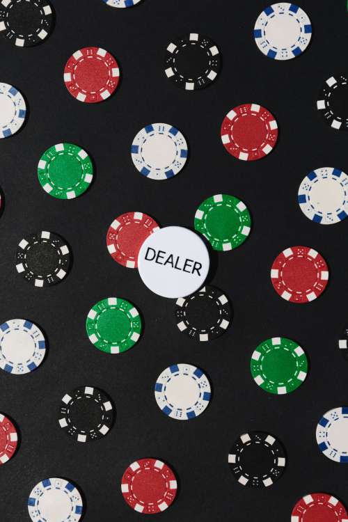Poker Chips On A Black Table Surface Photo