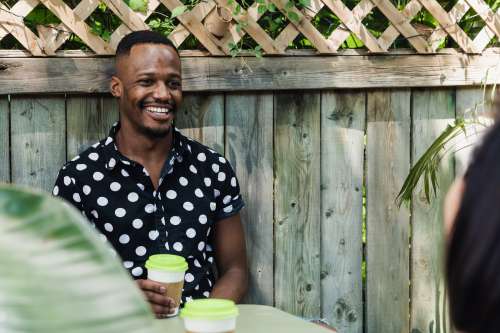 Man Drinking Coffee In Polkadot Shirt Photo