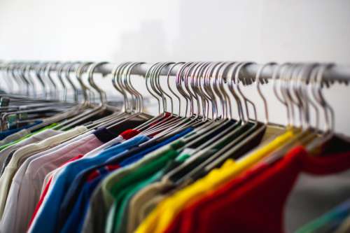 Multiple Colored Shirts Along A Rail Photo