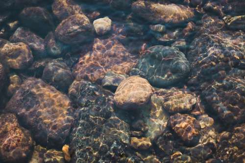 Rocks In The Shallow Waters Photo