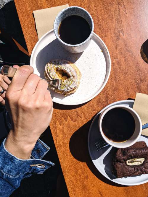 Aerial shot of a girl enjoying her coffee and dessert break