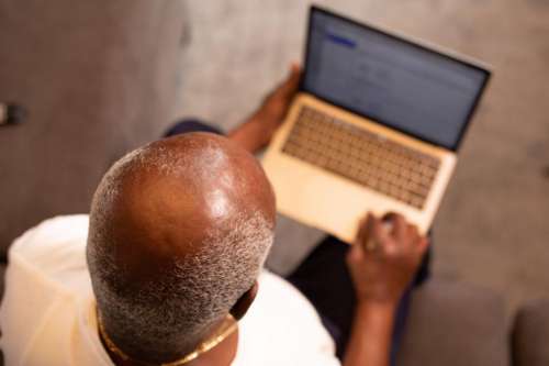 Older Man working on laptop at home