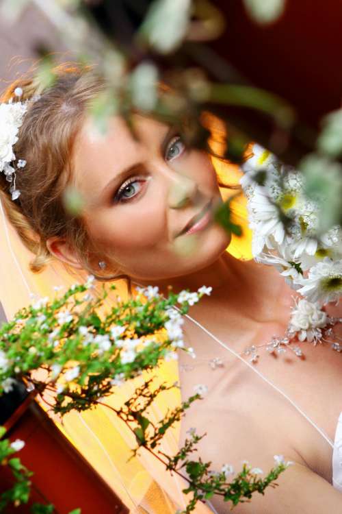 bride looking at camera through plants