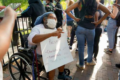 Man with Sign Protesting Racism