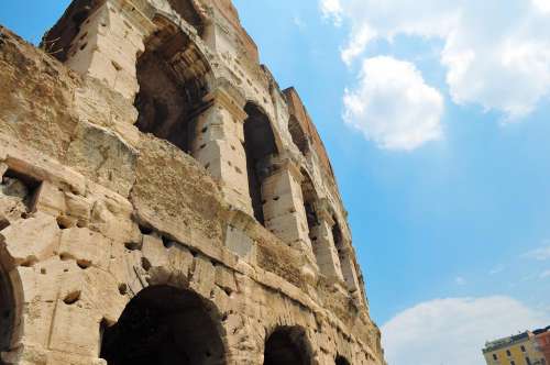 Angled View Of Coliseum In Rome With Blue Sky