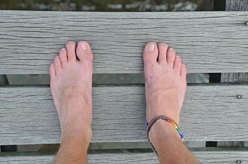 Well Travelled Mans Feet On Wood With Friendship anklet