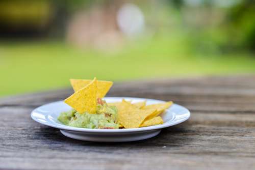 Fresh Guacamole And Chips On White Plate