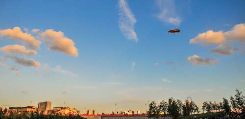 Airship In A Blue Sky With Clouds