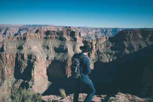 Man Wearing Cowboy Hat Looking At Grand Canyon