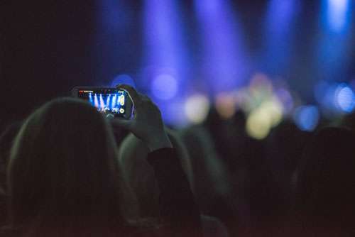 Girl Filming Live Concert On Smartphone