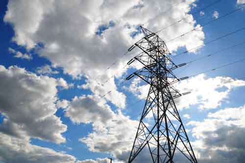 Electricity Pylon In A Dramatic Blue Cloudy Sky