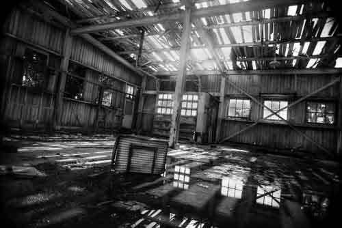 Dramatic Derelict Building With Suitcase In Water