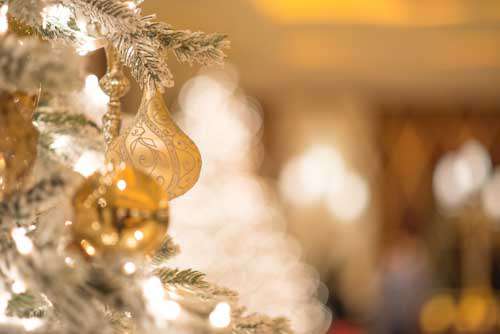 Close Up Of Gold Christmas Tree Decoration With Bokeh