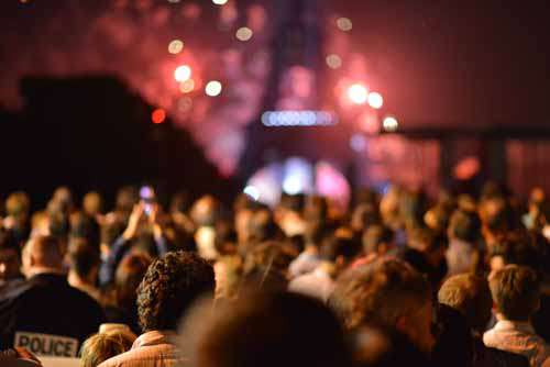 Crowd Of People At Night In Front Of Eiffel Tower