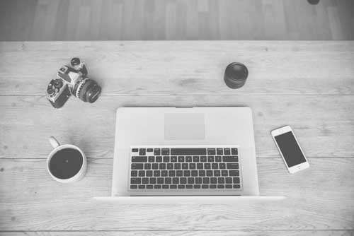 Laptop, Retro Camera, Coffee And Smartphone on Wooden Desk