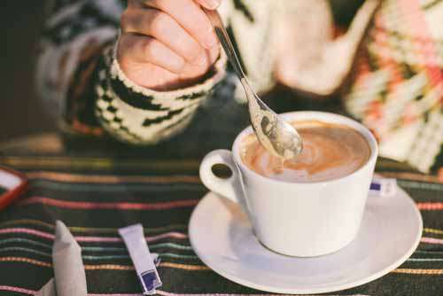 Woman Stirring Cappuccino Coffee