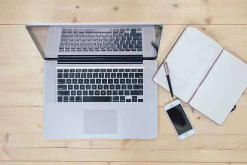 Laptop, Notebook & Smartphone On Wooden Desk