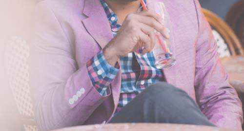 Man Wearing Casual Pink Jacket Drinking From A Glass
