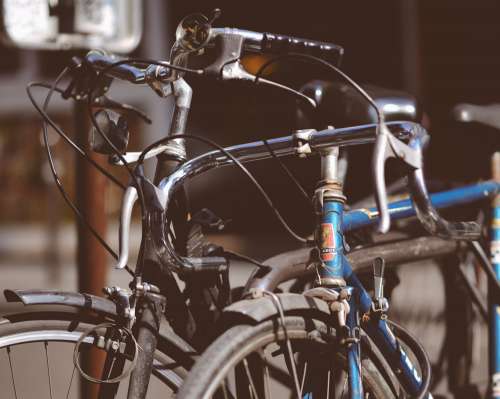 Two Old City Bikes Locked To Post