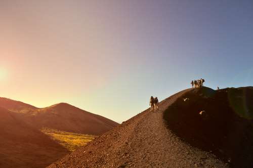Group Of People Hiking Up A Mountain Ridge