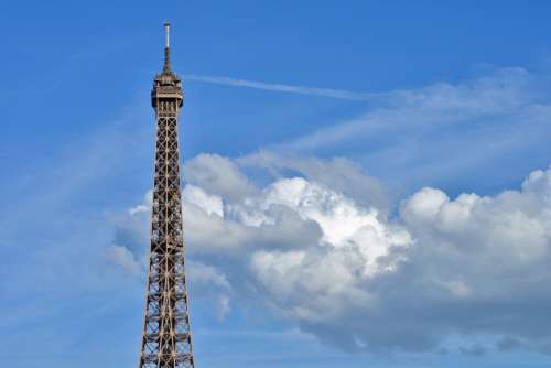 Top Of Eiffel Tower And Blue Cloudy Sky