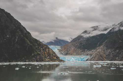 Glacier In Alaska With Dramatic Mountains