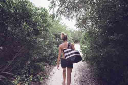 Girl With Beach Bag Walking In Nature